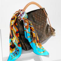 Monogrammed Artsy Louis Vuitton shoulder bag with Hermès silk scarf. Both available at Designer Exchange, Syosset, (516) 422-2270