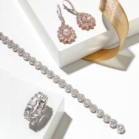 Diamond drop earrings in 18K white and rose gold with brown pear, rose cut and pink diamonds; Forevermark Center of My Universe diamond bracelet in 18K white gold and round diamonds; Diamond Eternity Wedding Band in white gold with emerald cut diamonds. All available at SVS Fine Jewelry, Oceanside, (516) 766-2614